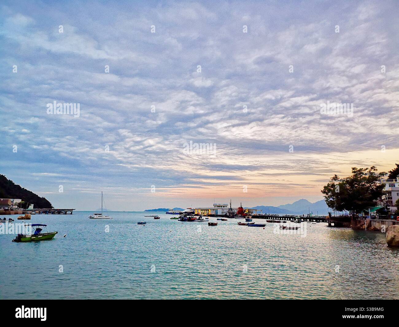 dawn over the Yung shue wan pier on lamma island in Hong kong. - Smartphone Captured Stock Image