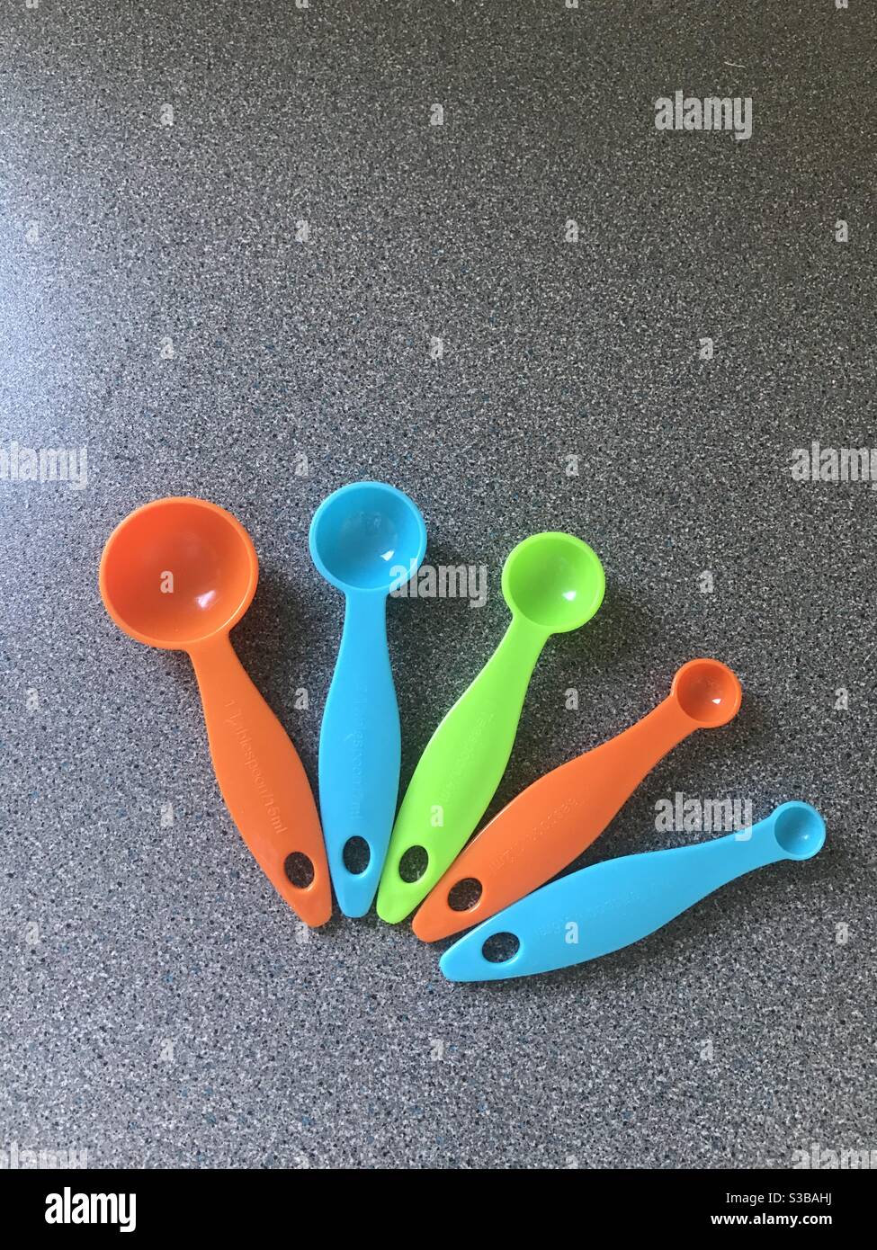 Coloured measuring spoons Stock Photo - Alamy