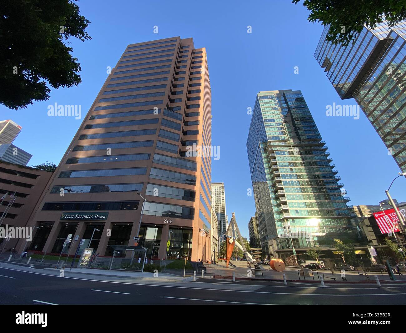 LOS ANGELES, CA, AUG 2020: looking up at tall office buildings in the South Park area of Downtown with public art on street corner - Smartphone Captured Stock Image