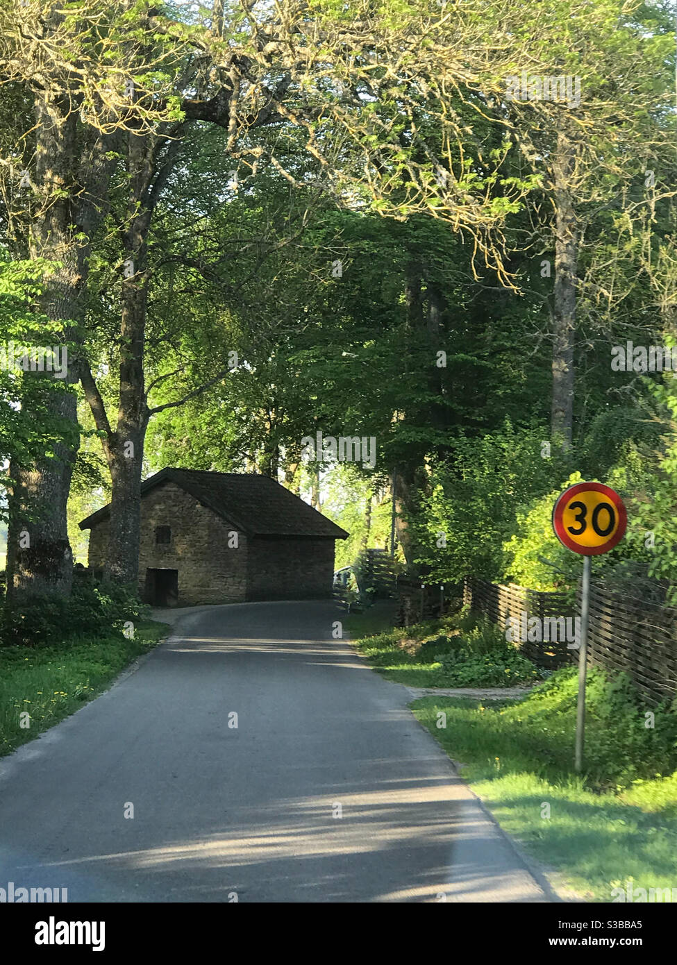 Summer road with ancient house Stock Photo