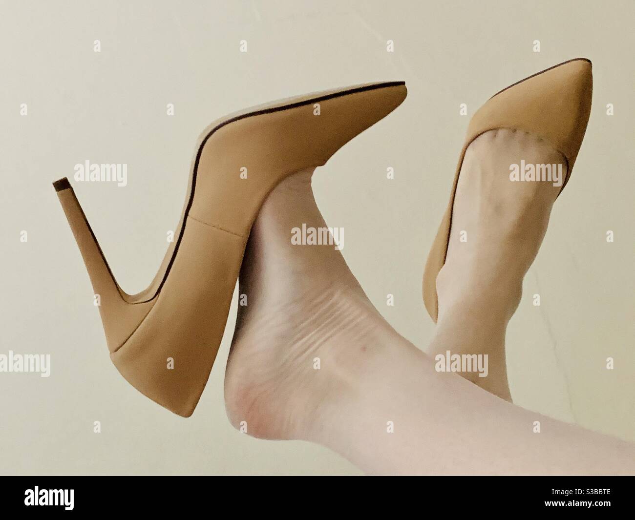 High heels on a woman’s white-stocking-clad feet - Smartphone Captured Stock Image