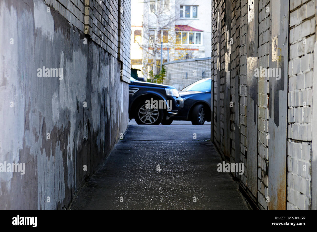 Inside the courtyard through a narrow passage between the houses - Smartphone Captured Stock Image