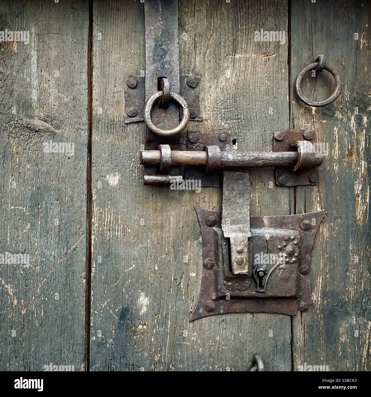Medieval iron lock on a heavy wooden door Stock Photo Alamy