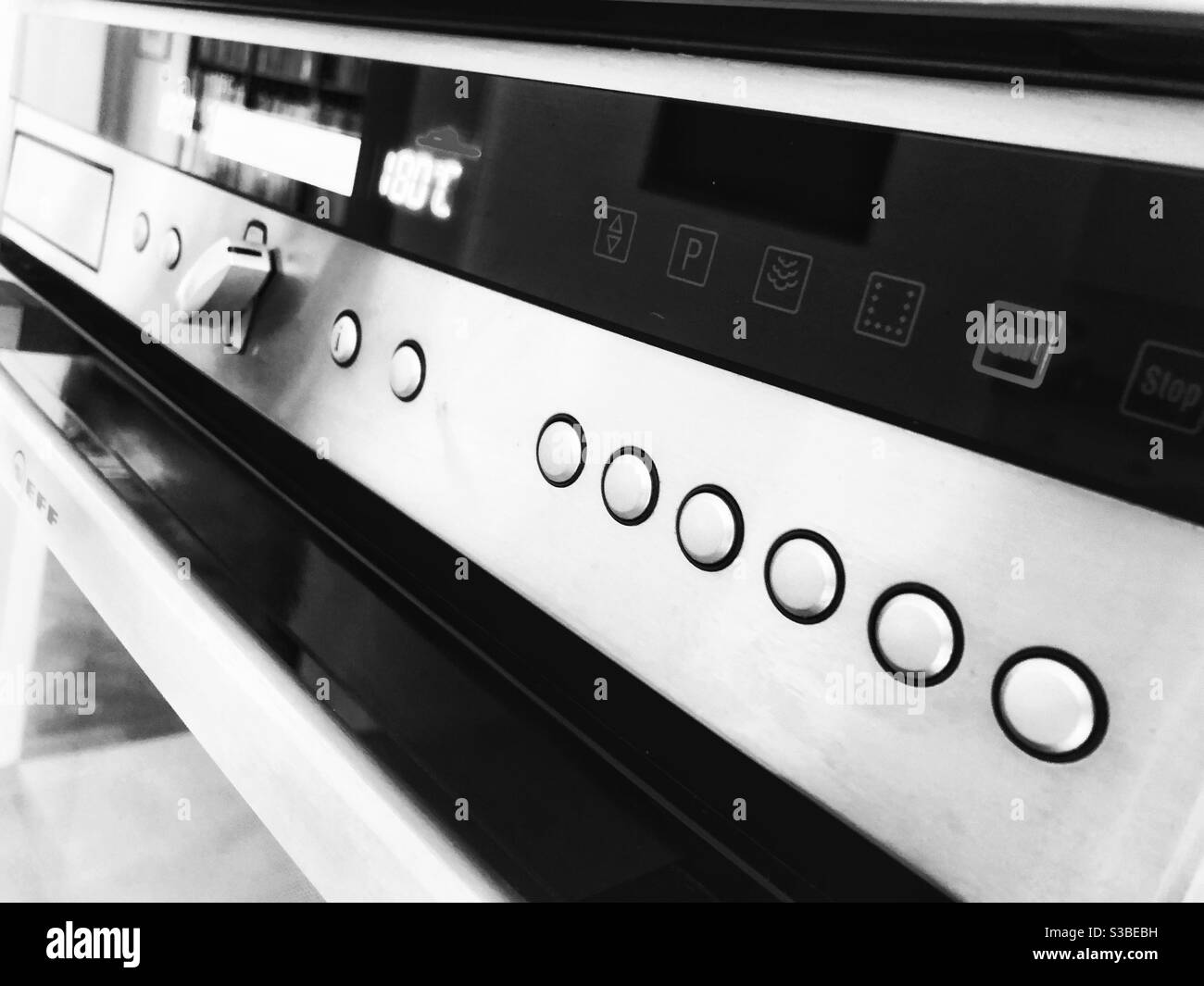 Graphic, high contrast black and white still life of built in oven front at an angle. - Smartphone Captured Stock Image