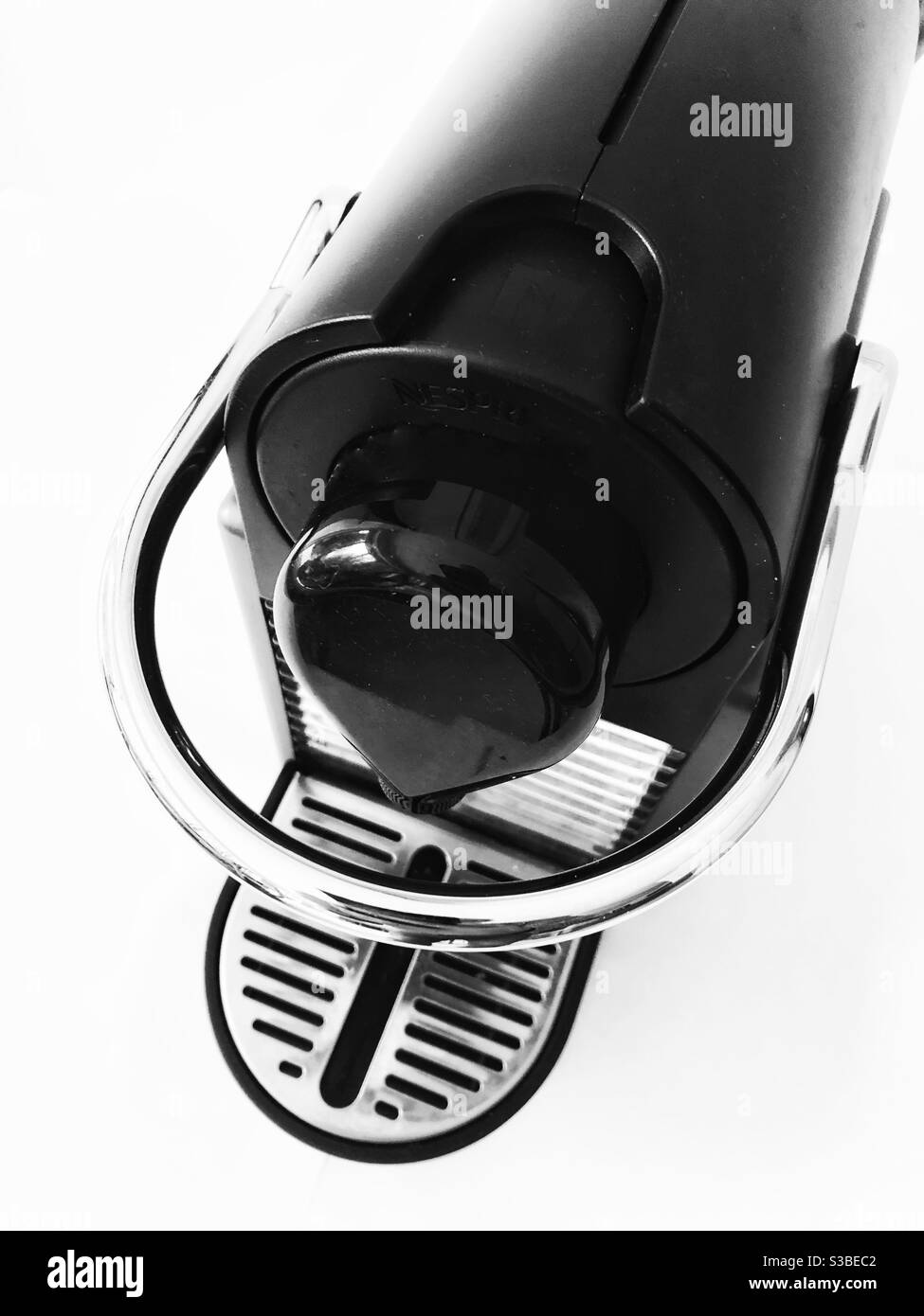 Graphic, high contrast black and white still life of coffee maker from above against a white background. - Smartphone Captured Stock Image