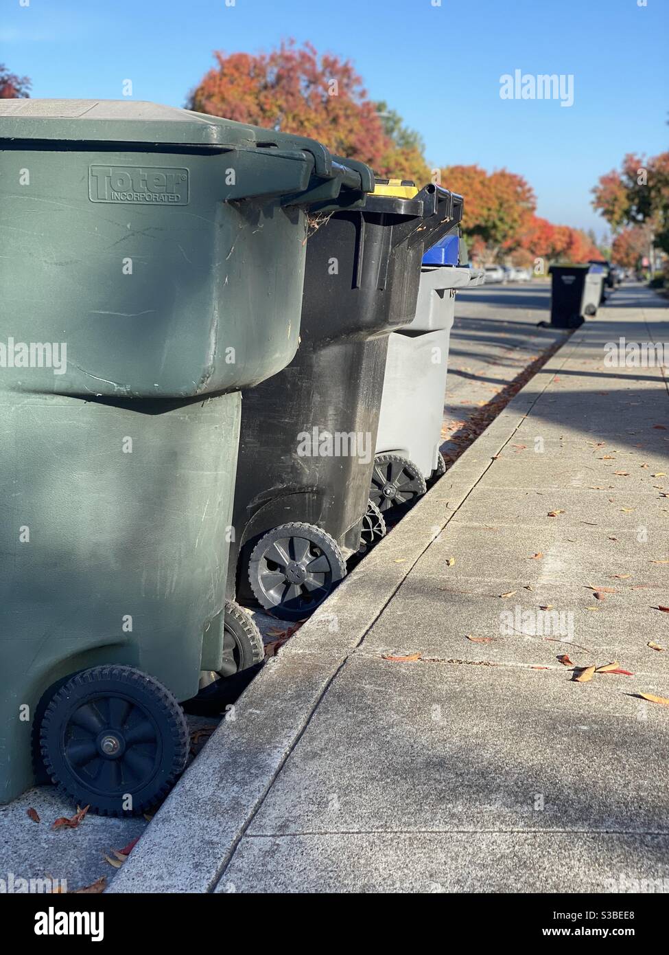 Trash cans lined up in a suburban California neighborhood Stock Photo Alamy