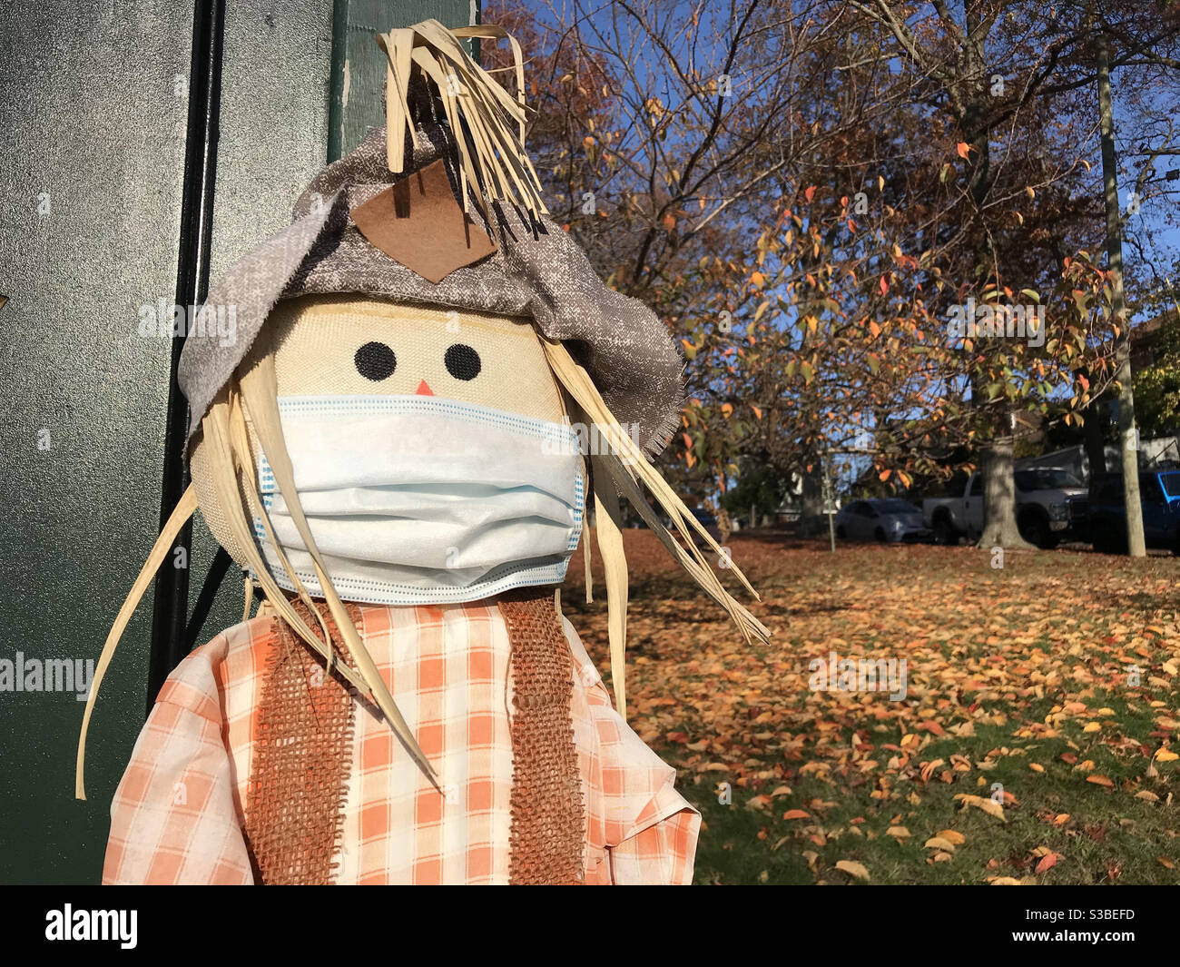 Scarecrow Wearing A Face Mask During The COVID-19, Coronavirus Pandemic, Autumn Decor Stock Photo