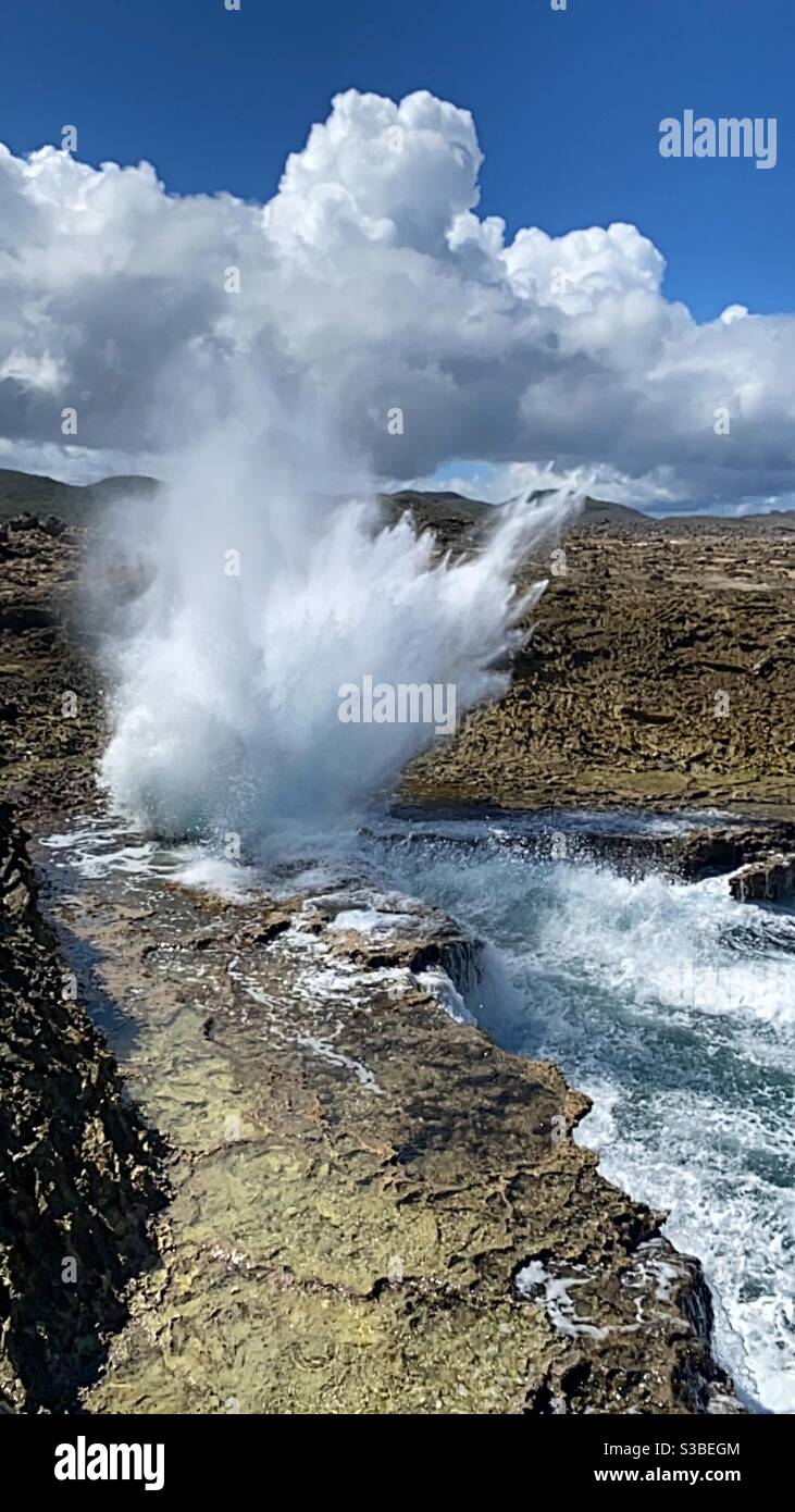 Rough sea and high waves hitting slamming against rocks at Shete Boka Park Curacao Stock Photo
