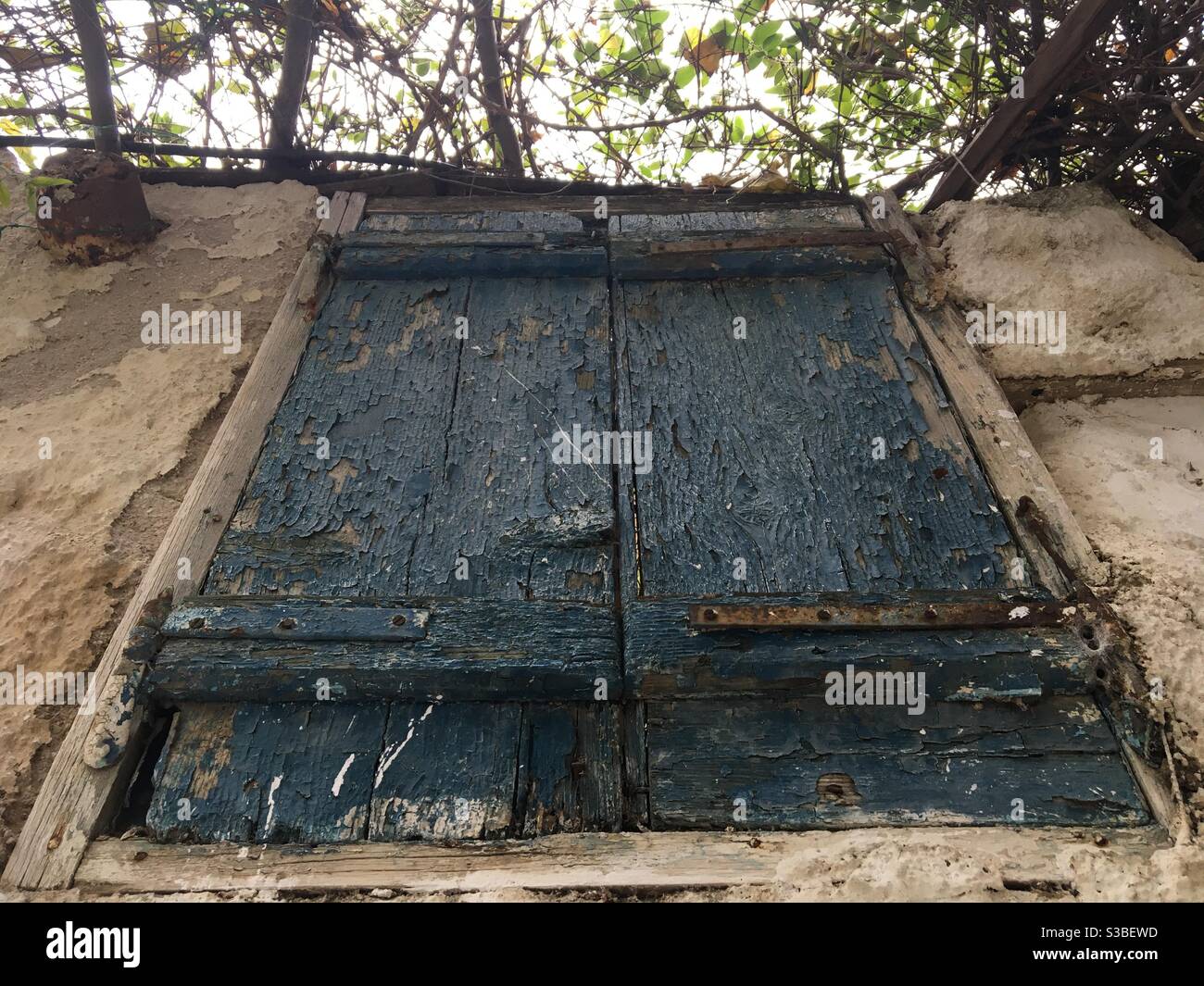 old wooden window, aged and decayed by time and abandonment, in the traditional district of Plaka, in Athens, Greece, Europe. - Smartphone Captured Stock Image