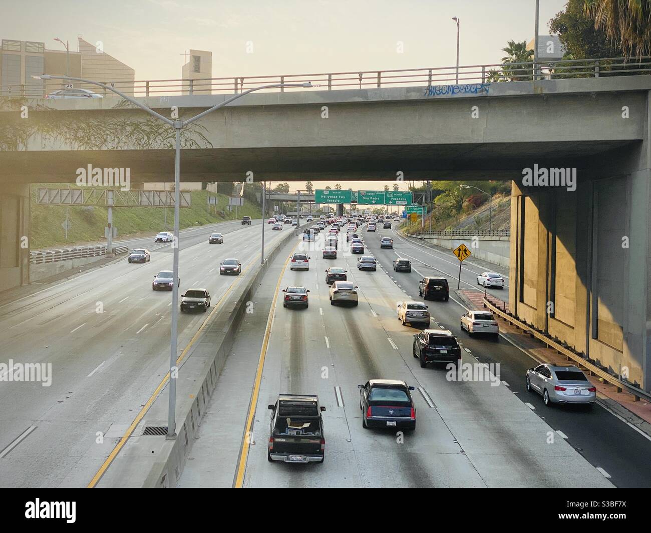 LOS ANGELES, CA, AUG 2020: view from Downtown bridge, looking down at traffic on the CA-101 and US-110 freeway interchange in Downtown, at sunset - Smartphone Captured Stock Image