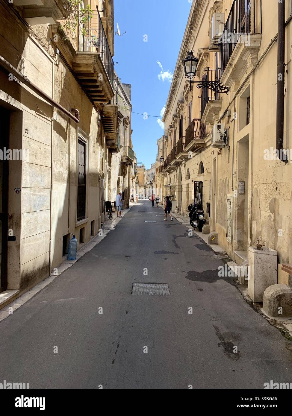 Typical street in Lecce with baroque architecture in Apulia, Southern Italy Stock Photo
