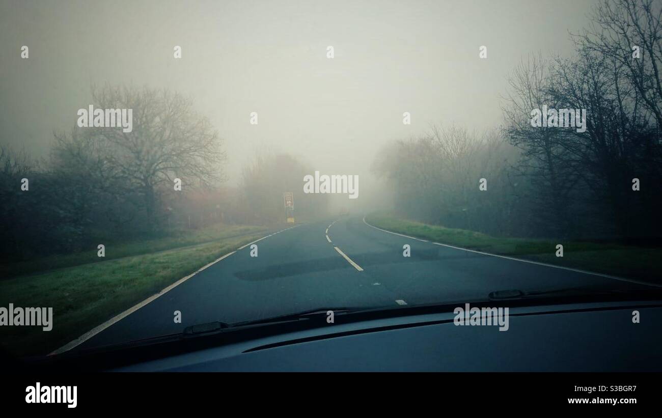 A photograph of a misty view along a road from inside a car - Smartphone Captured Stock Image