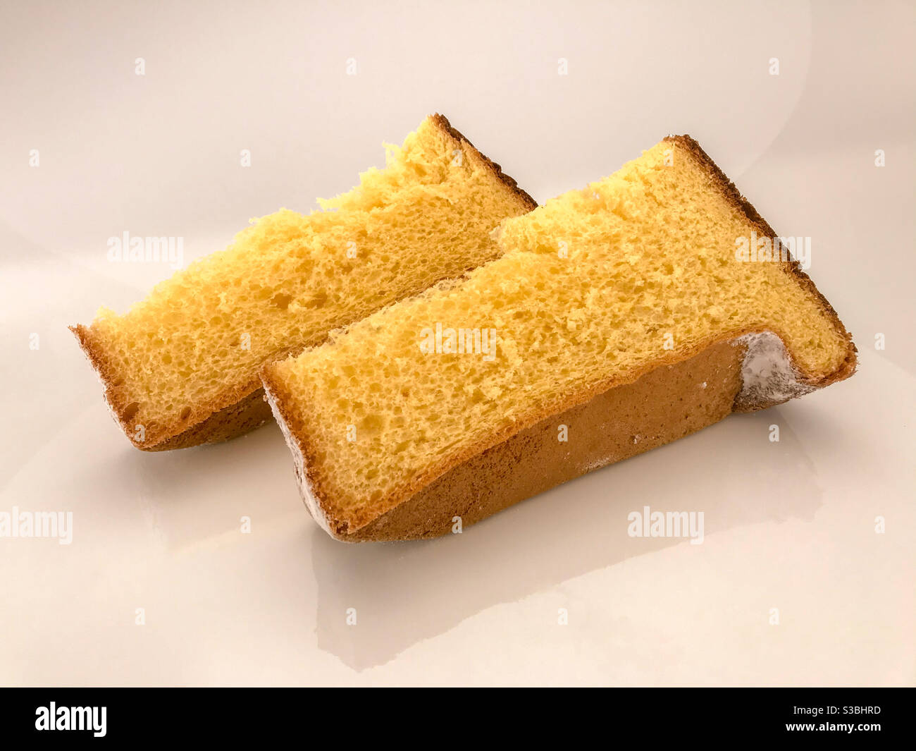 Pandoro, typical Italian Christmas cake, two slices with icing sugar isolated on white - Smartphone Captured Stock Image