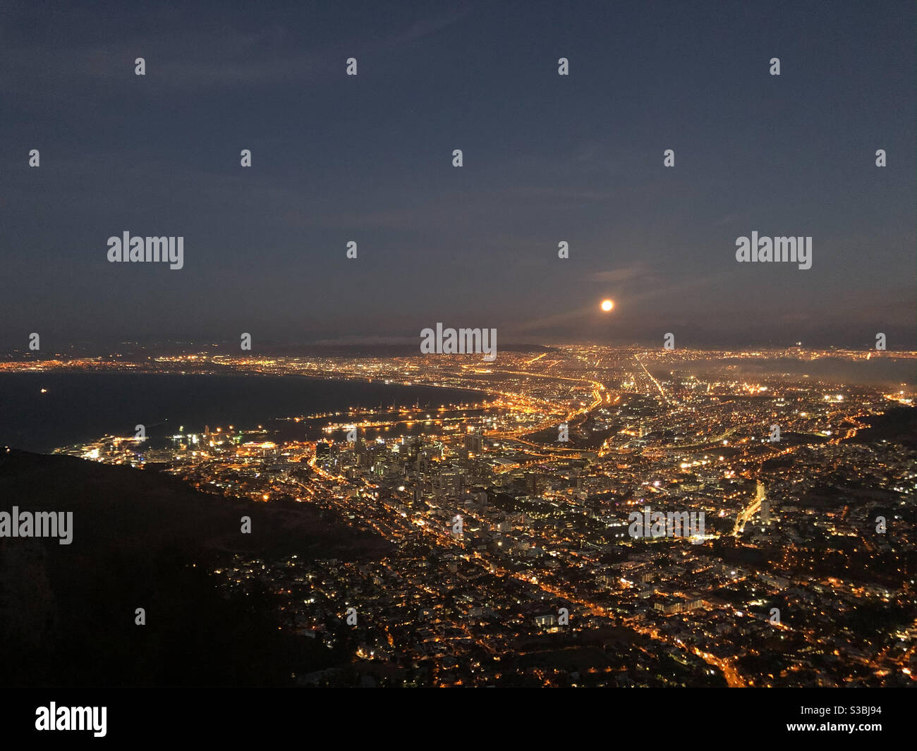 Full Moon over lit up Cape Town Stock Photo