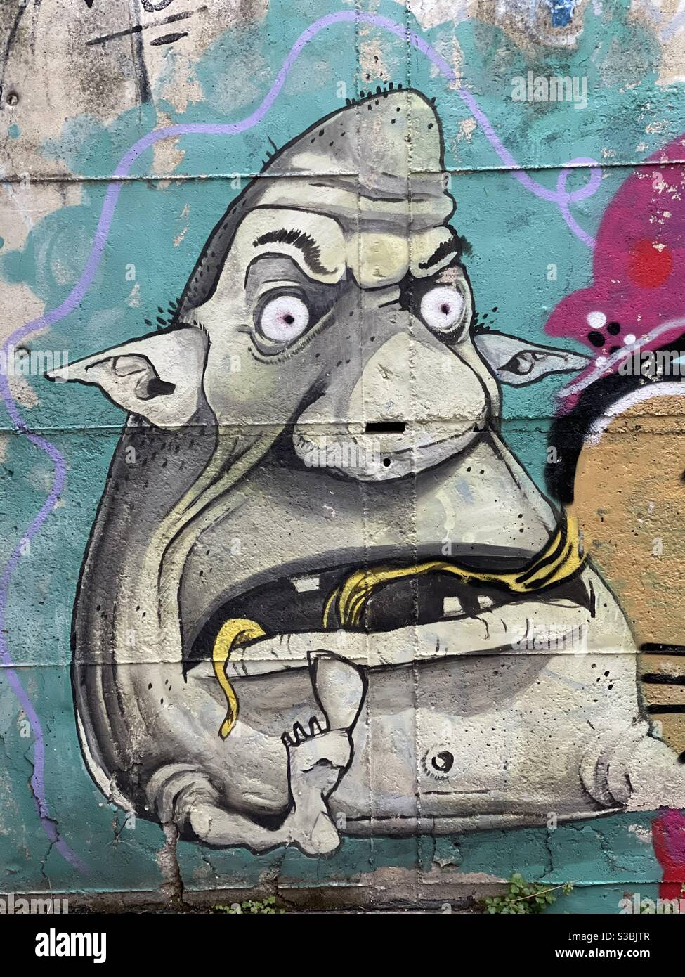 Fat monster design on a wall - Smartphone Captured Stock Image