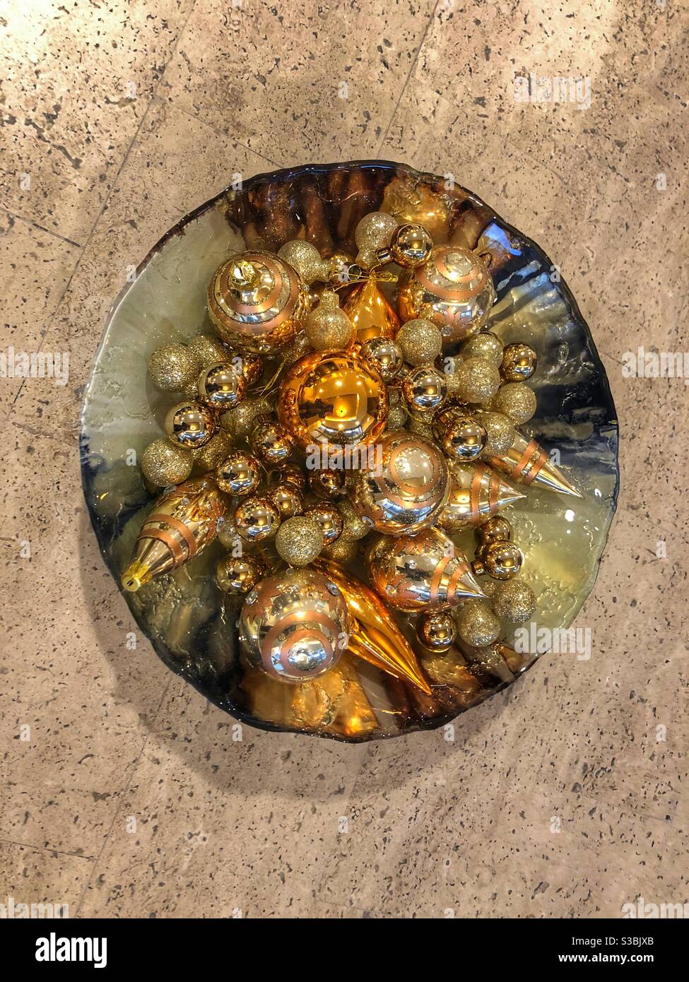 A decorative bowl with shiny objects. - Smartphone Captured Stock Image