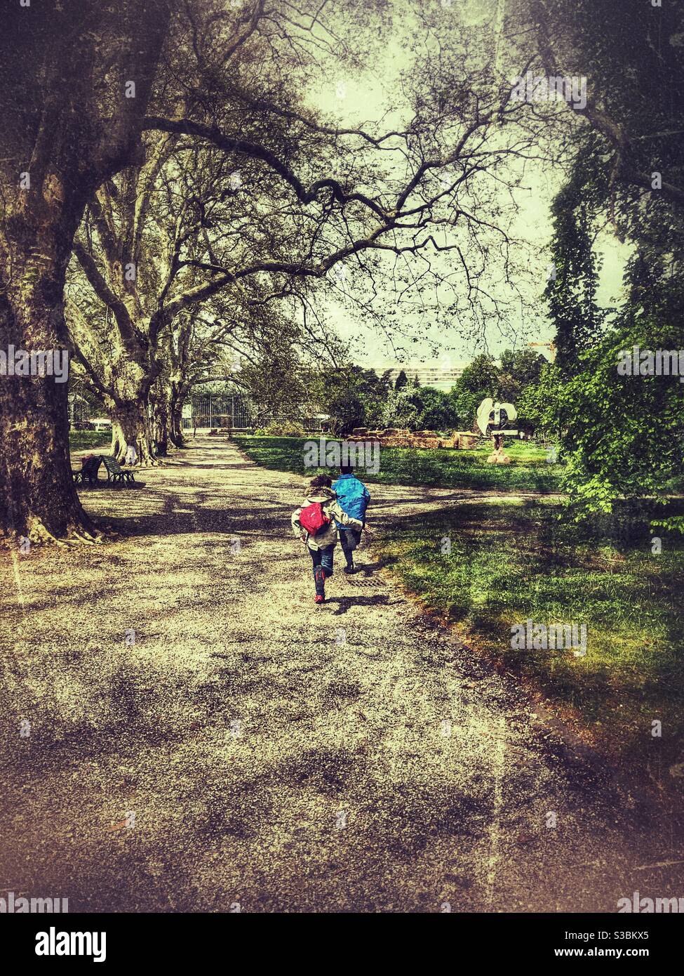 Two kids running the garden Stock Photo