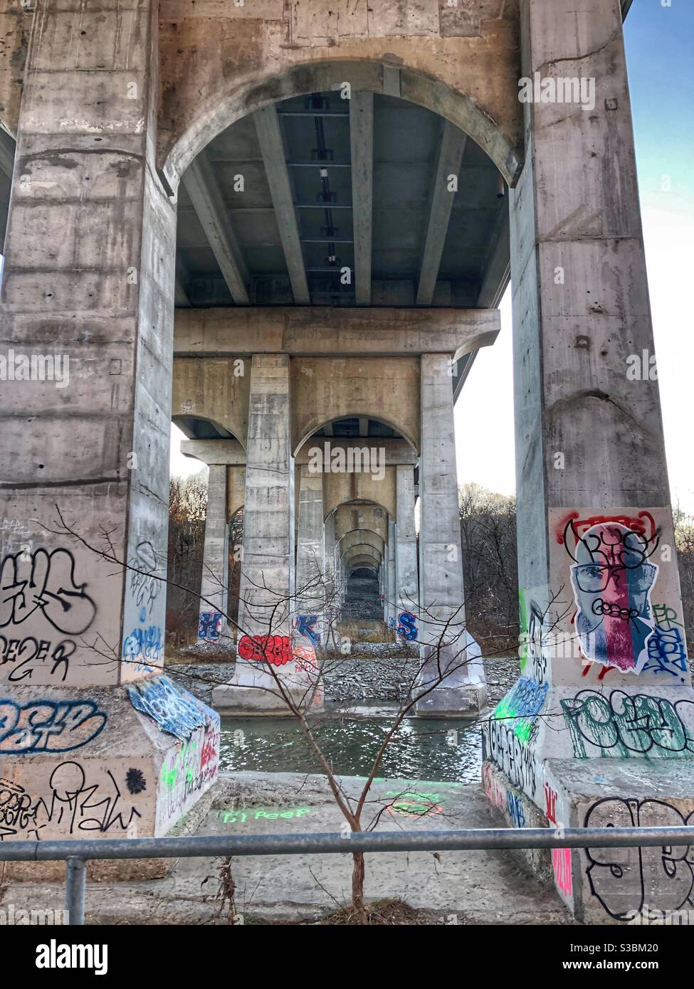 Graffiti on the pillars of a bridge underpass. Stock Photo