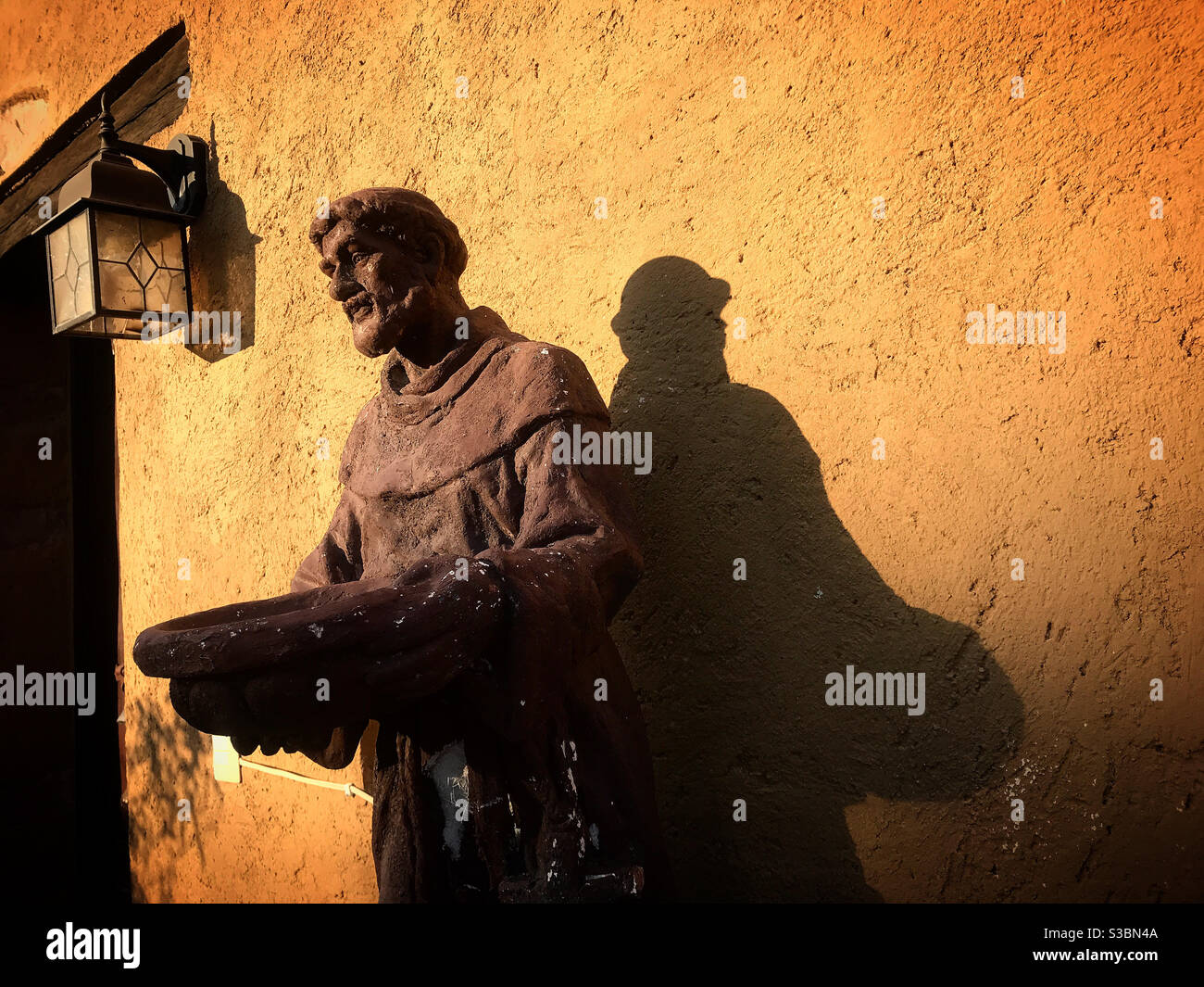 A sculpture of Saint Francis of Assisi decorates Hostal Medieval hotel in Peña de Bernal, Queretaro, Mexico - Smartphone Captured Stock Image