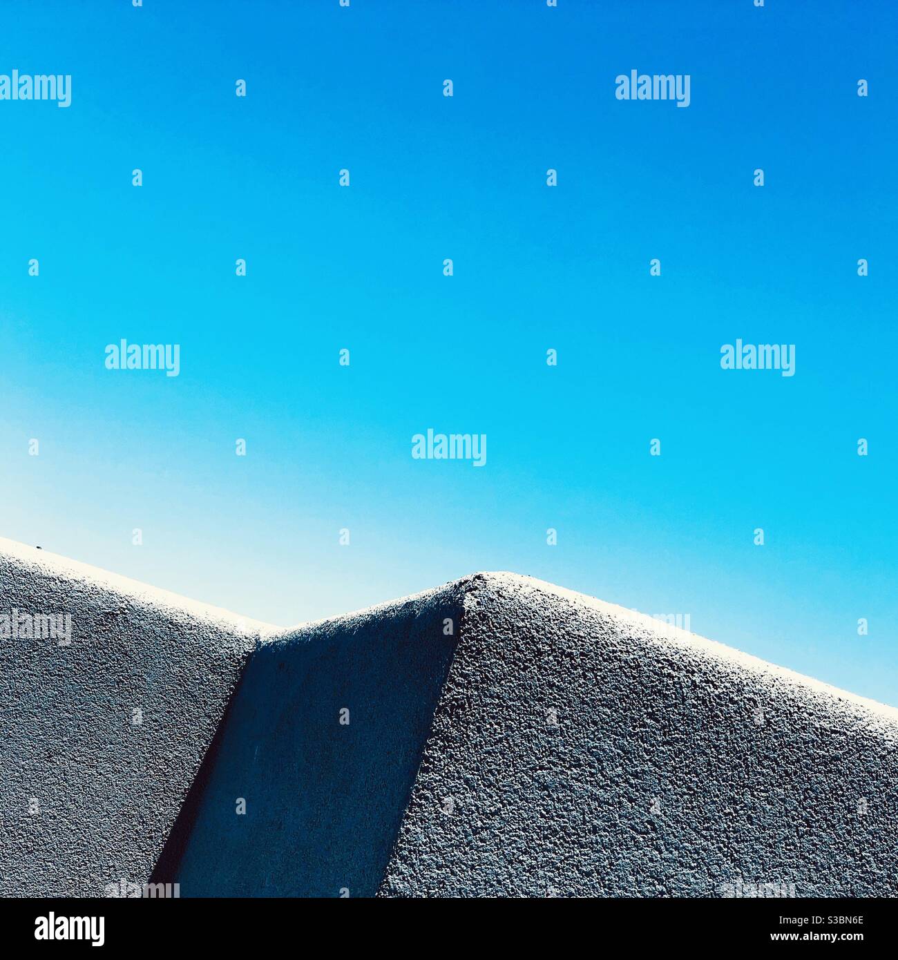Concrete edge of a rooftop balcony in the bright New Mexico sunlight at the upscale Nob Hill neighborhood. - Smartphone Captured Stock Image