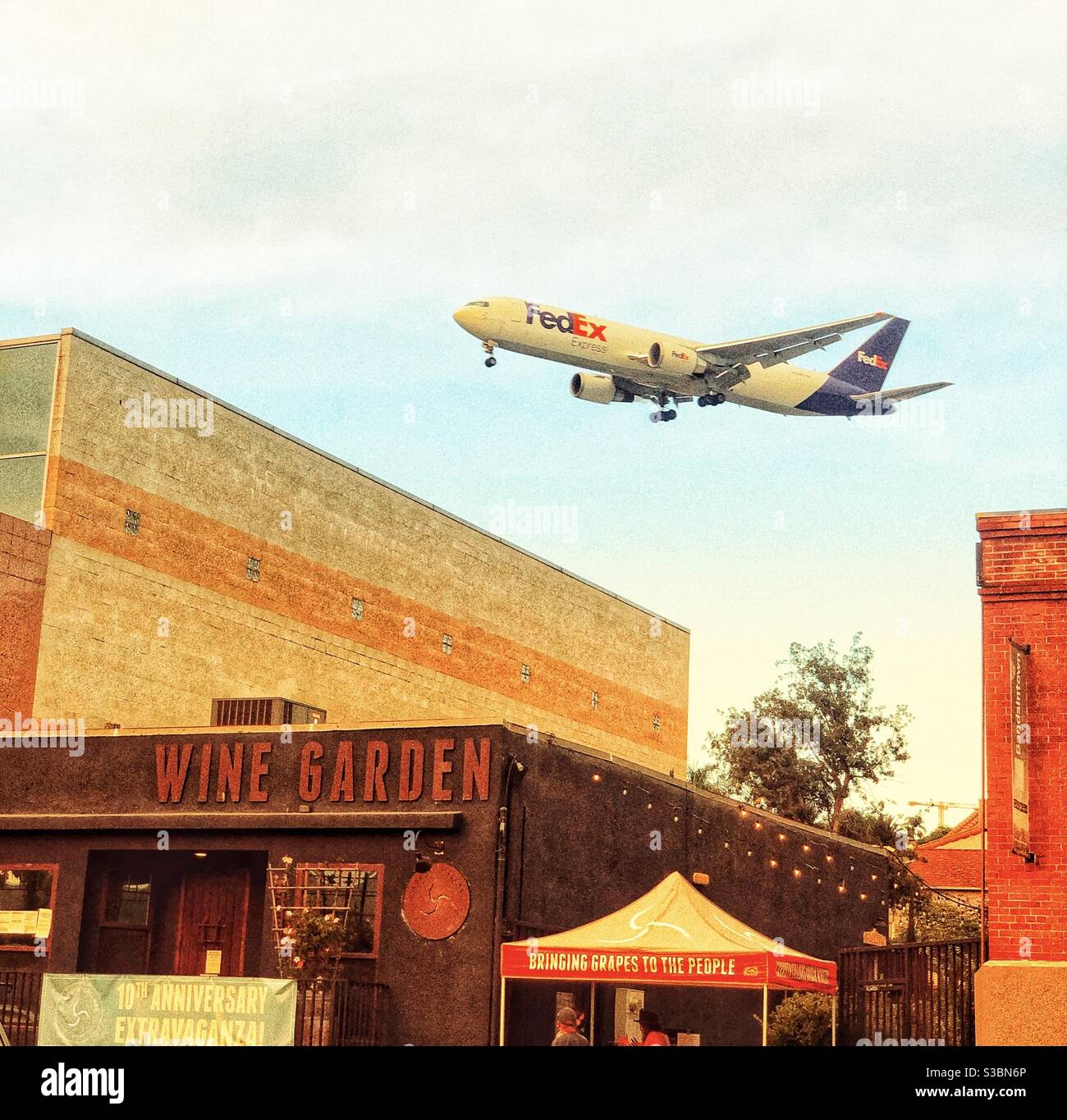 Plane flying low over buildings on landing in San Diego CA - Smartphone Captured Stock Image