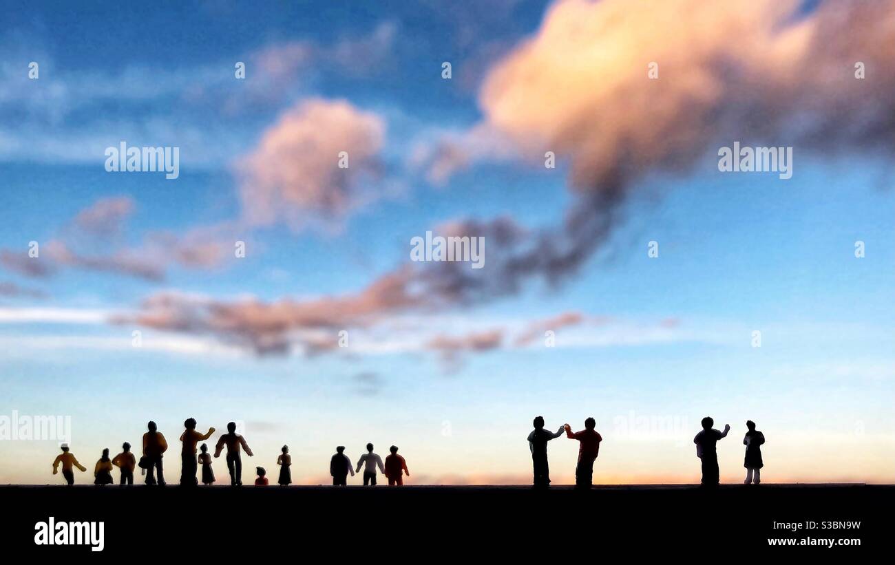 Silhouetted crowd of toy figures watching the sky - Smartphone Captured Stock Image