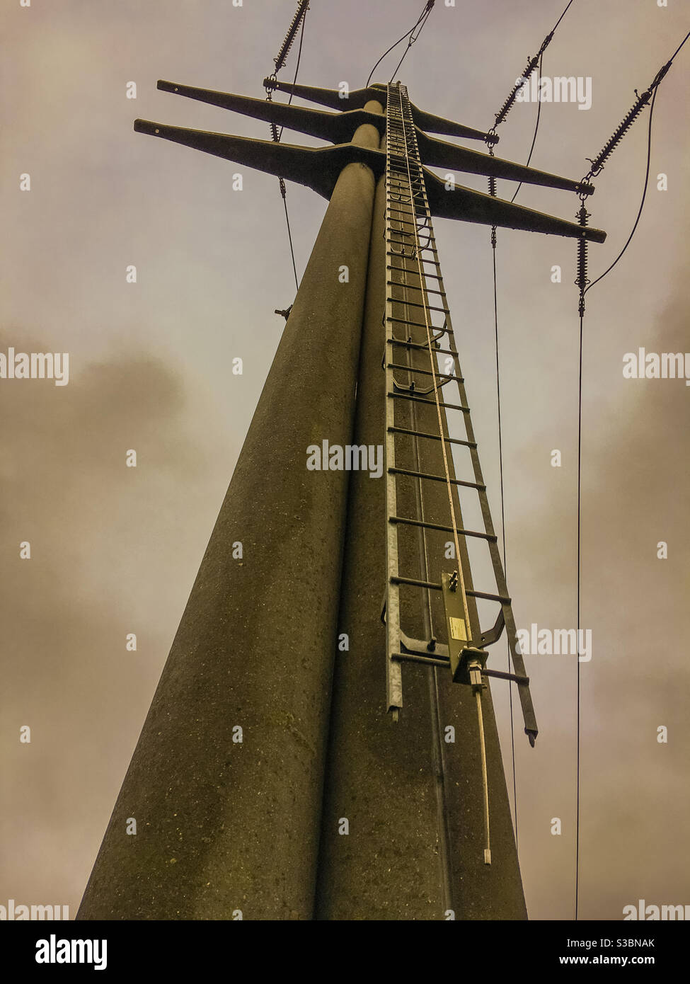 electricity high voltage transmission tower against dramatic sky - Smartphone Captured Stock Image