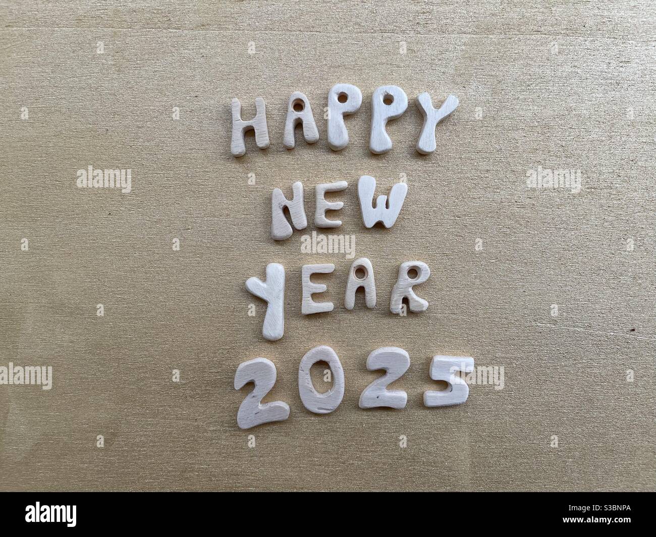 Happy New Year 2025 with wooden letters and numbers Stock Photo