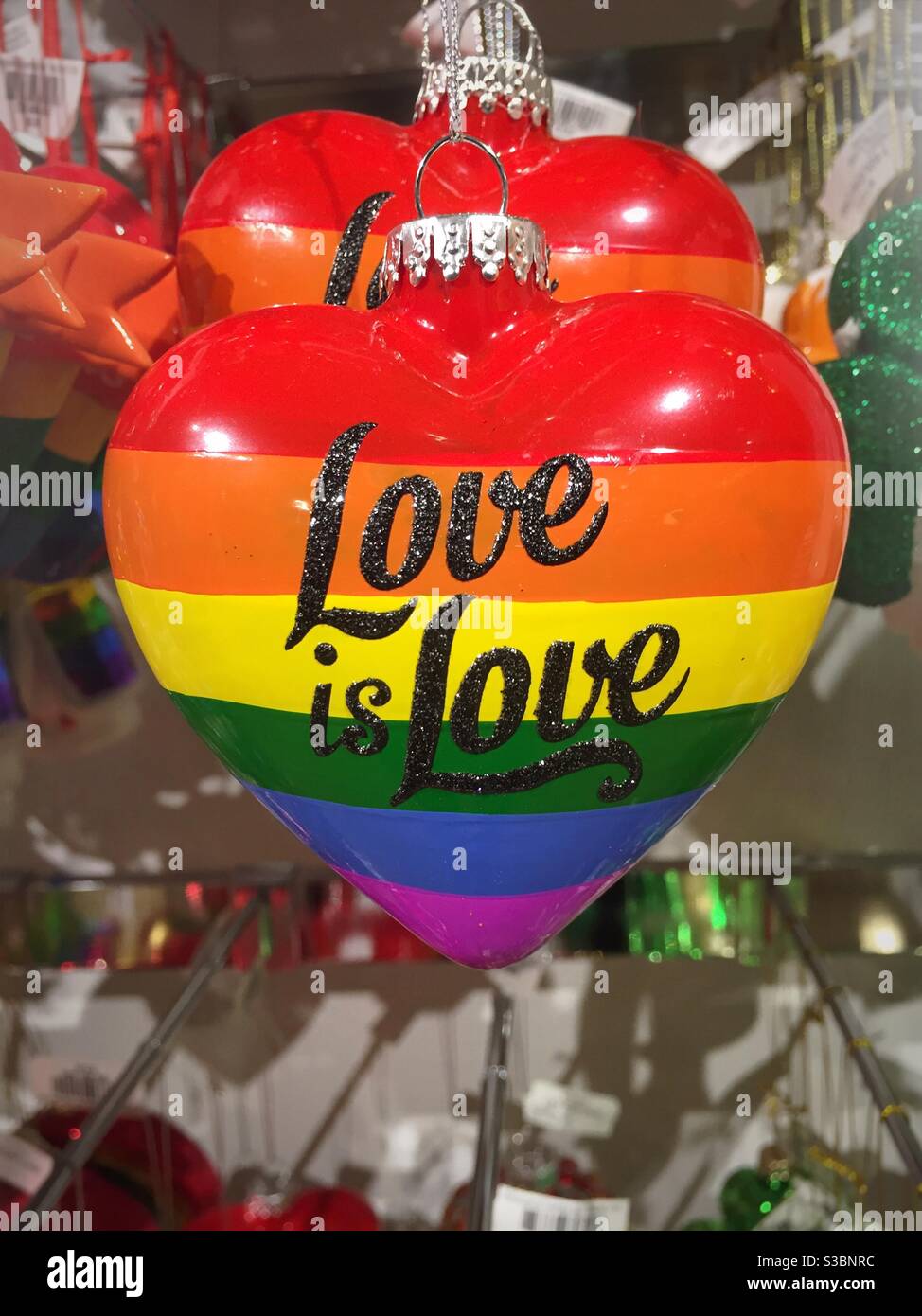 Ornament in the shape of a heart with the rainbow colors of LGBT “ Love is love“, USA - Smartphone Captured Stock Image