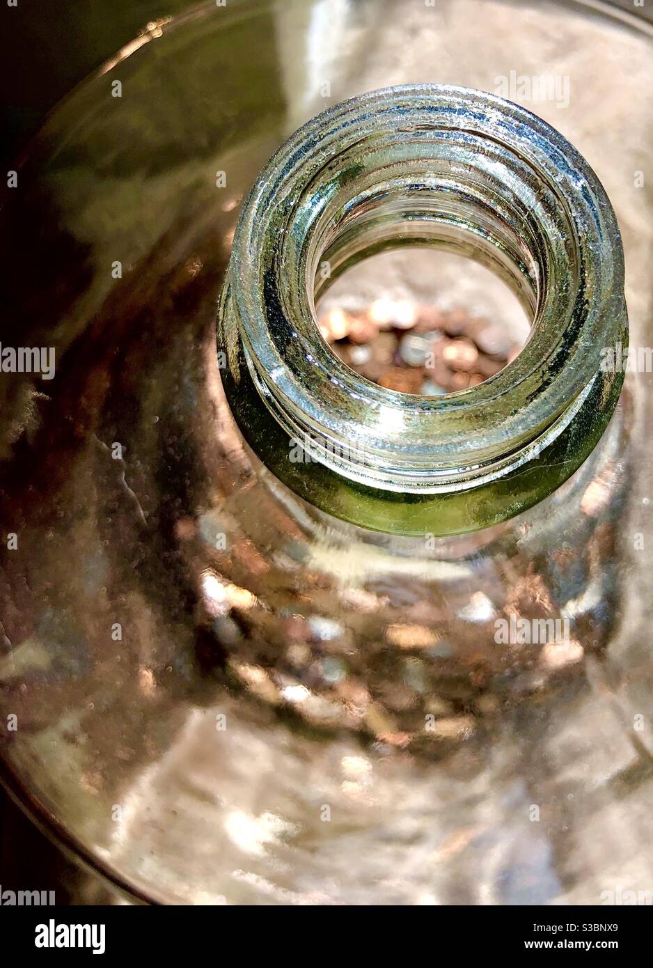 Spare change in glass jar Stock Photo