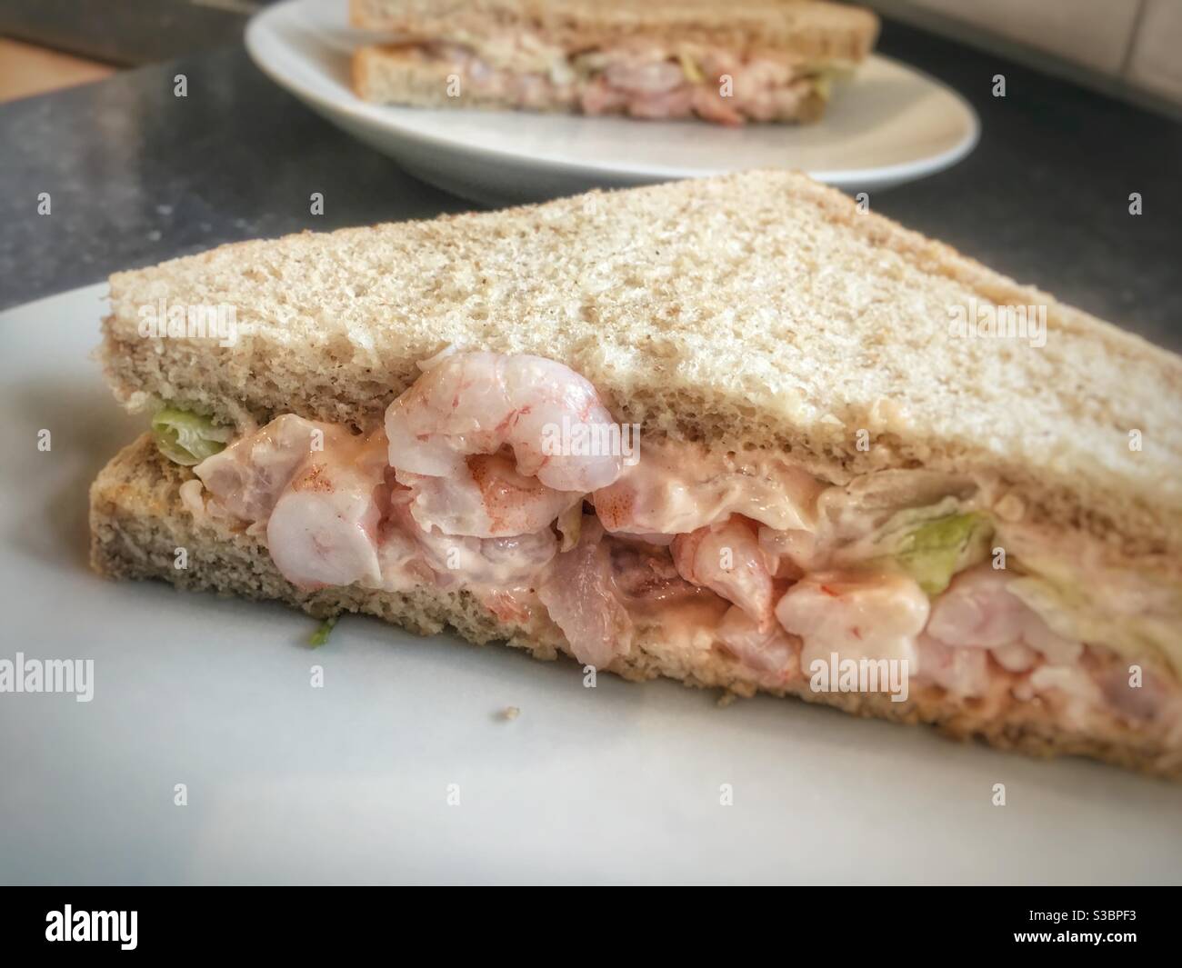 Prawn sandwich in brown wholemeal bread. - Smartphone Captured Stock Image