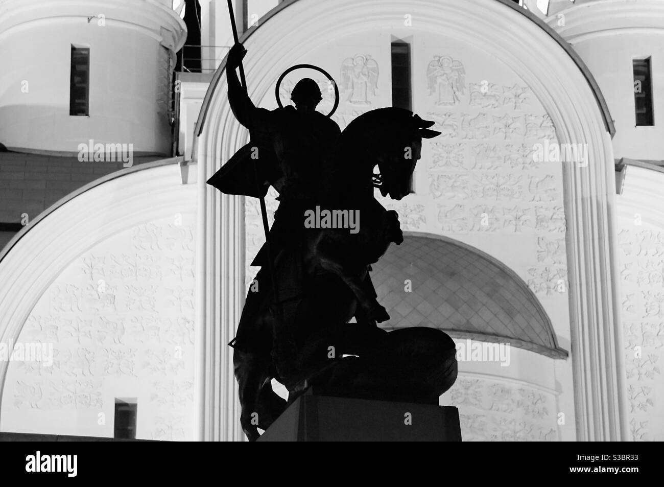 Silhouette of the monument to St. George the Victorious against the background of a large temple - Smartphone Captured Stock Image