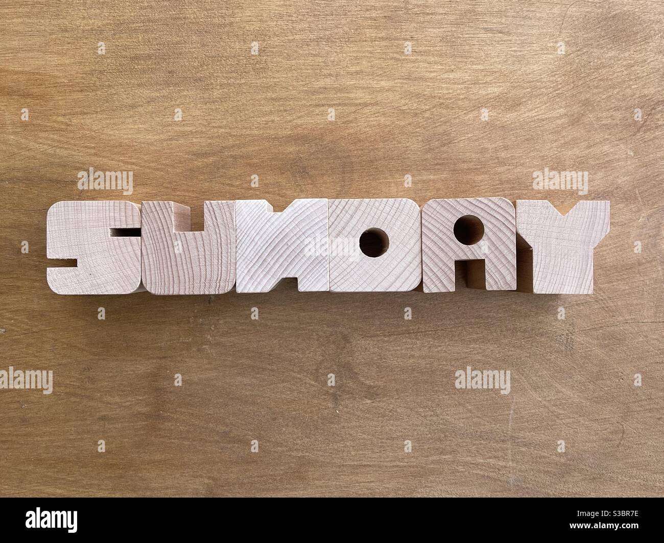 Sunday text composed with wooden letters over a wooden board - Smartphone Captured Stock Image