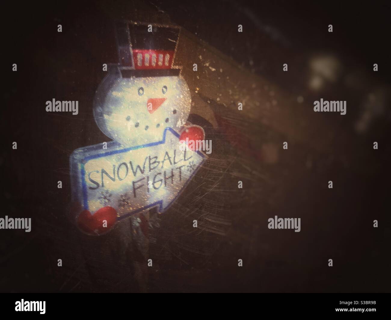 A snowball fight sign at night - Smartphone Captured Stock Image