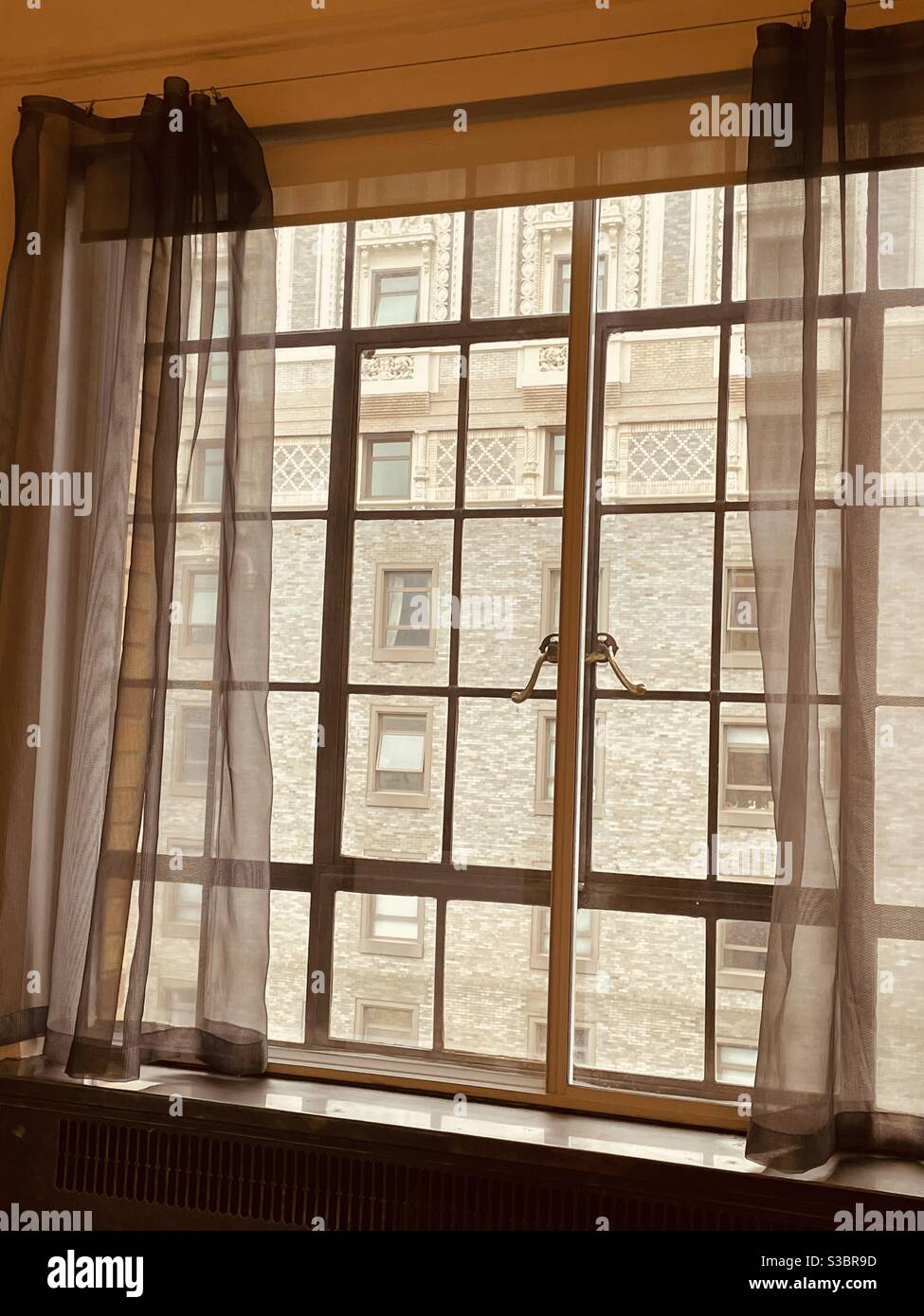 Charming Prewar historic building window at 10 Park Avenue with a view toward the architectural detail of the former Hotel Vanderbilt at 4 Park Avenue, New York City, NY, USA - Smartphone Captured Stock Image