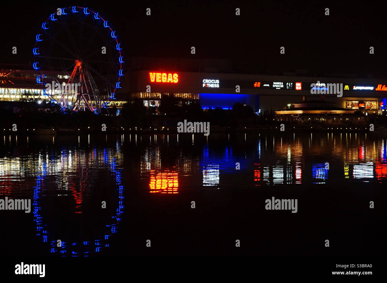 Evening city and the reflection of its lights in the river - Smartphone Captured Stock Image