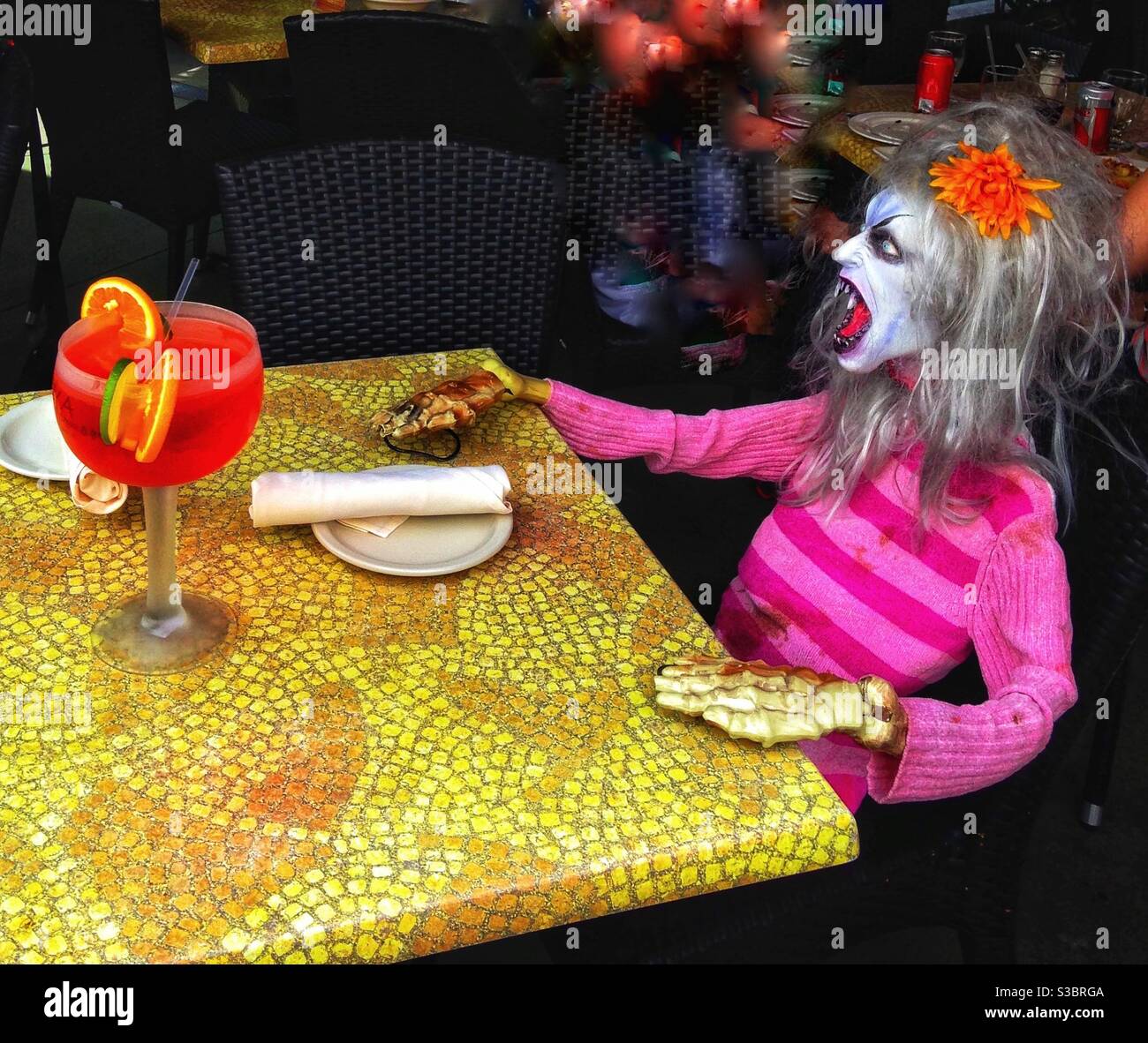 WAITER!!! Mannequin demanding service at an outdoor restaurant in South Beach, Miami, Florida. She has her cocktail but where is her food? - Smartphone Captured Stock Image