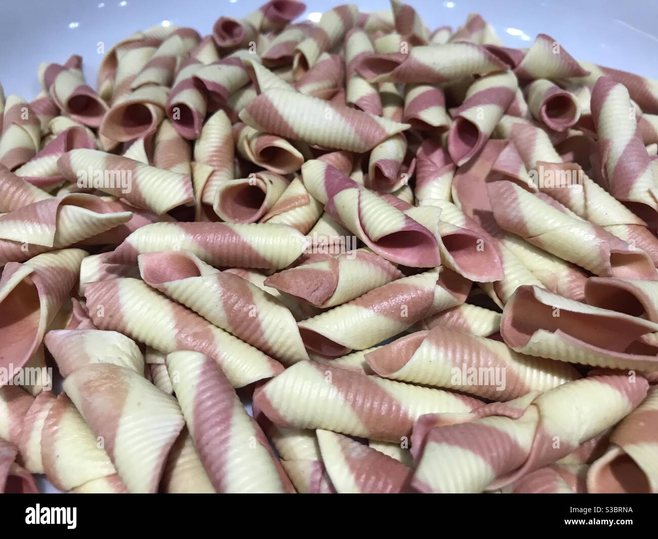 Closeup image of garganelli pasta with red beet - Smartphone Captured Stock Image