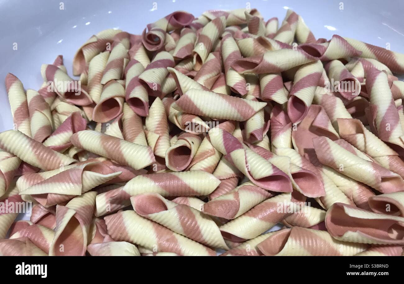Closeup image of garganelli pasta with red beet - Smartphone Captured Stock Image