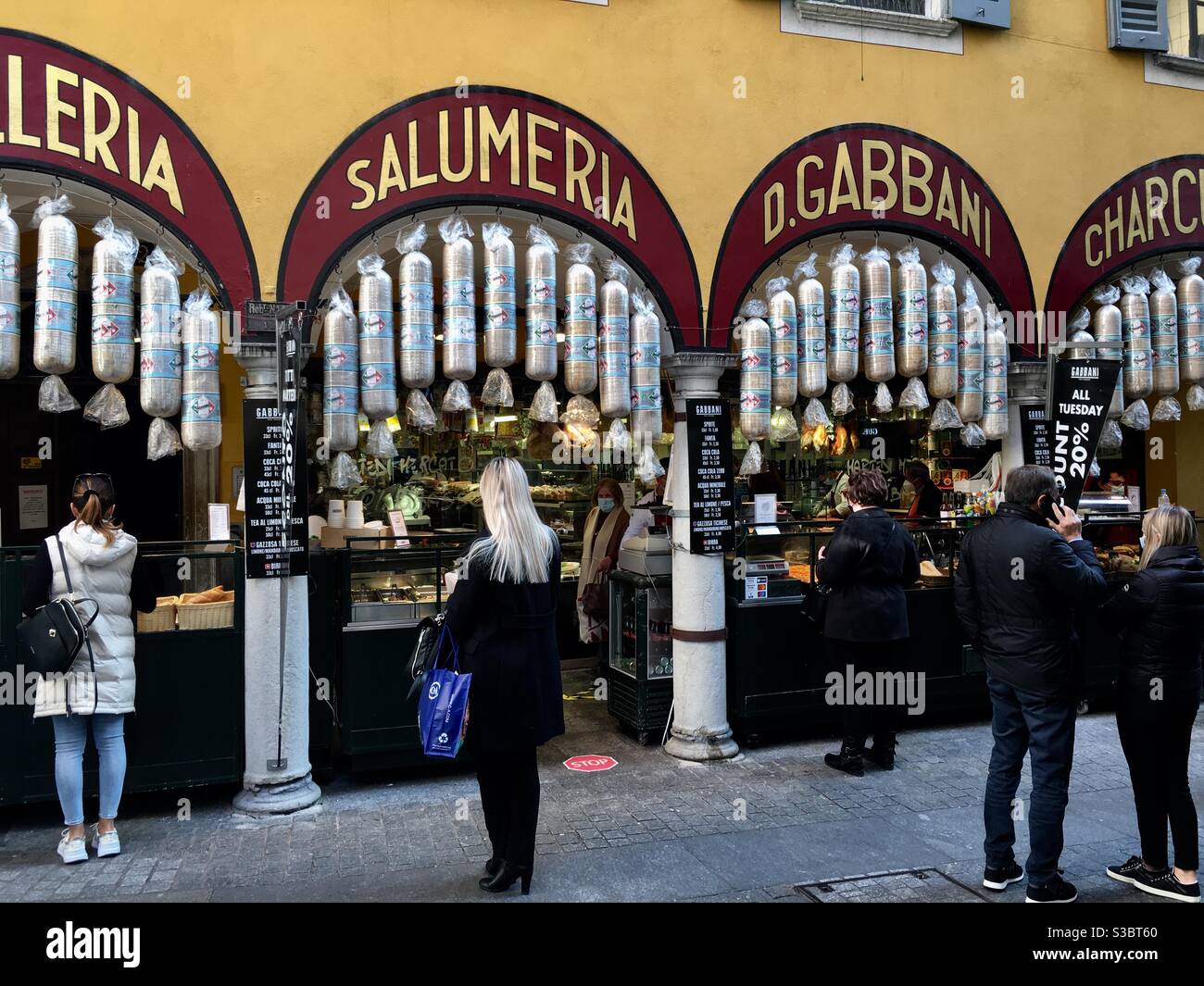 Butcher shop with take away food and Salami decor, people shopping with  social distancing due to Corona Lugano,Switzerland Stock Photo - Alamy