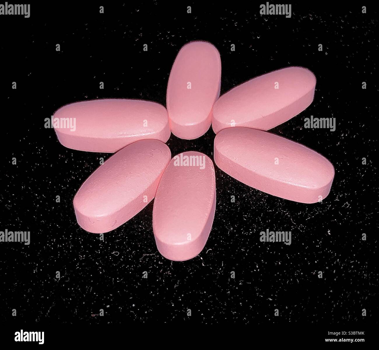 Vitamin flower Women’s pink vitamins form shape of a flower Stock