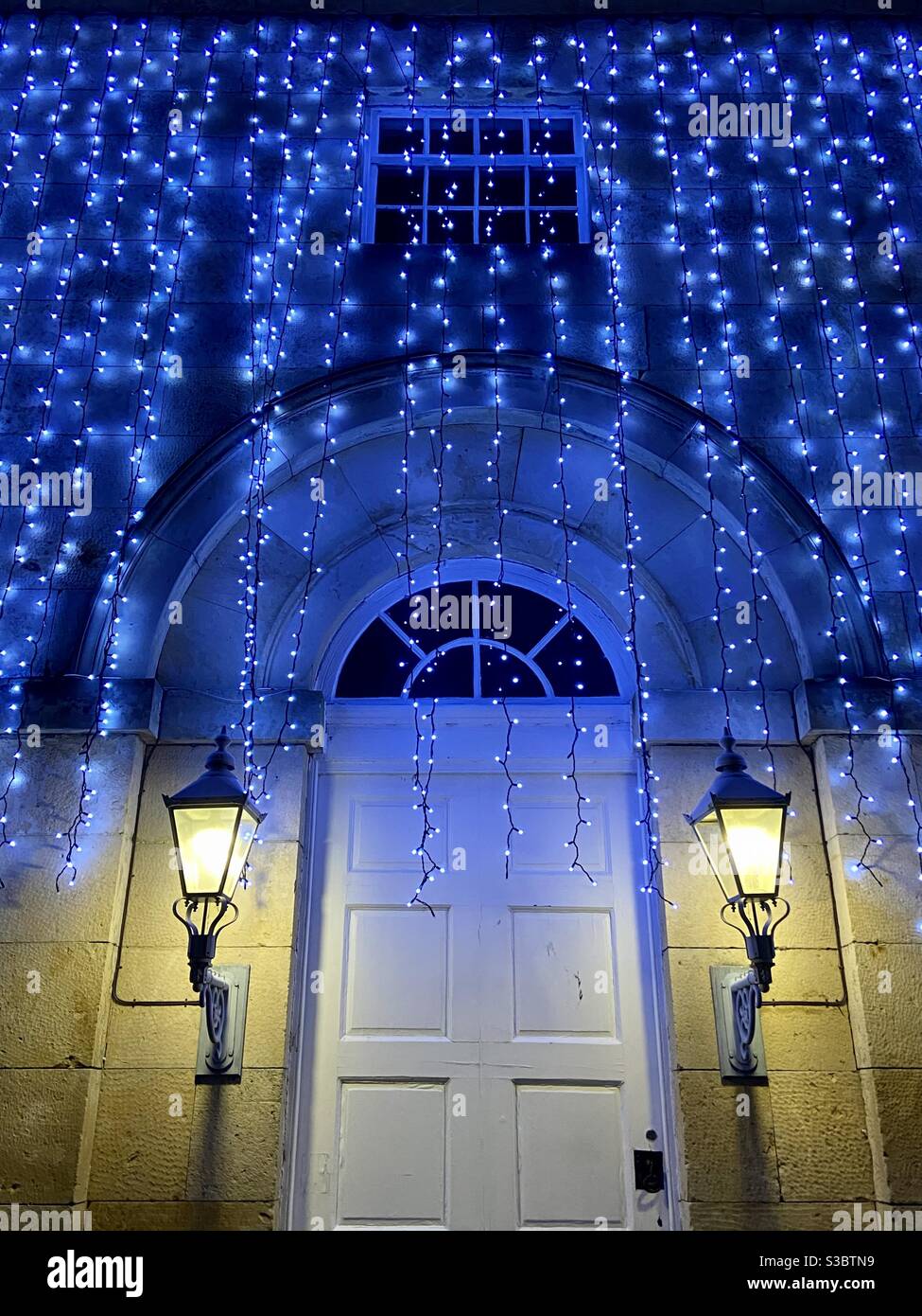Christmas lights over arched doorway Stock Photo Alamy