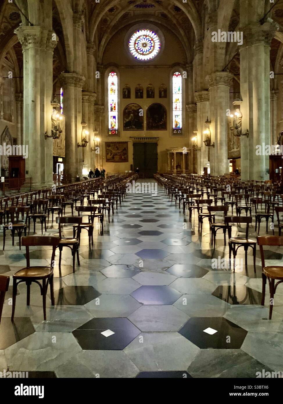 Social distancing in an Italian church with chairs spaced far apart in the central nave - Smartphone Captured Stock Image