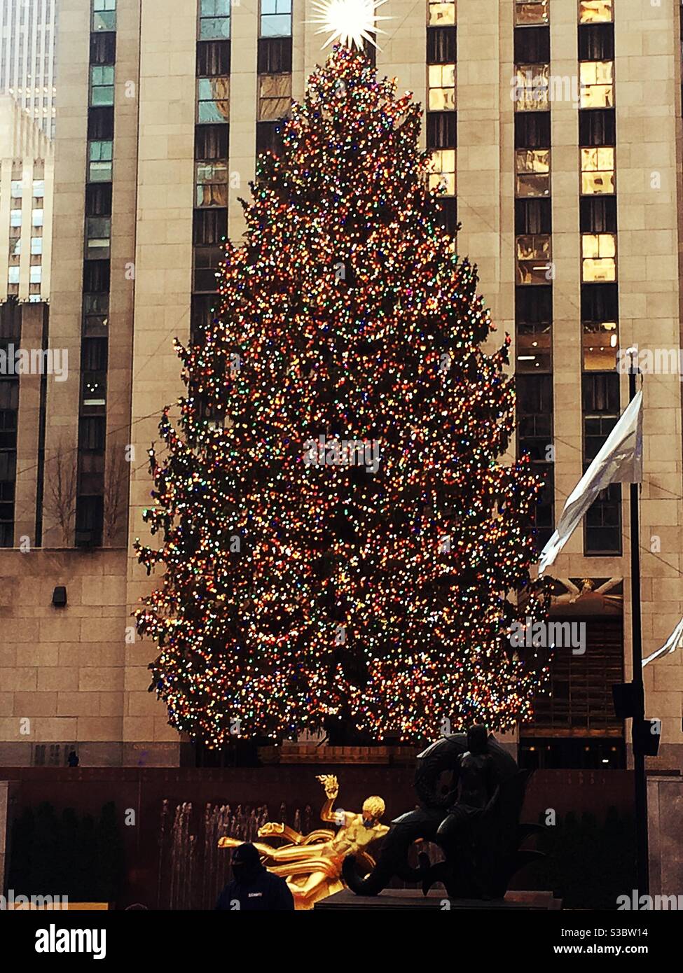 The Christmas tree in Rockefeller Center is an annual tradition celebrating the holiday season and it attracts thousands of people, NYC, USA - Smartphone Captured Stock Image