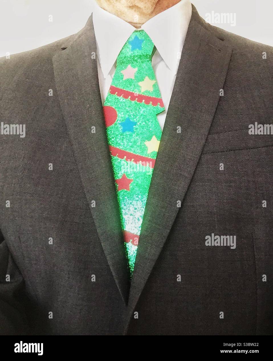 A businessman in a suit wearing a funny Christmas tie - Smartphone Captured Stock Image