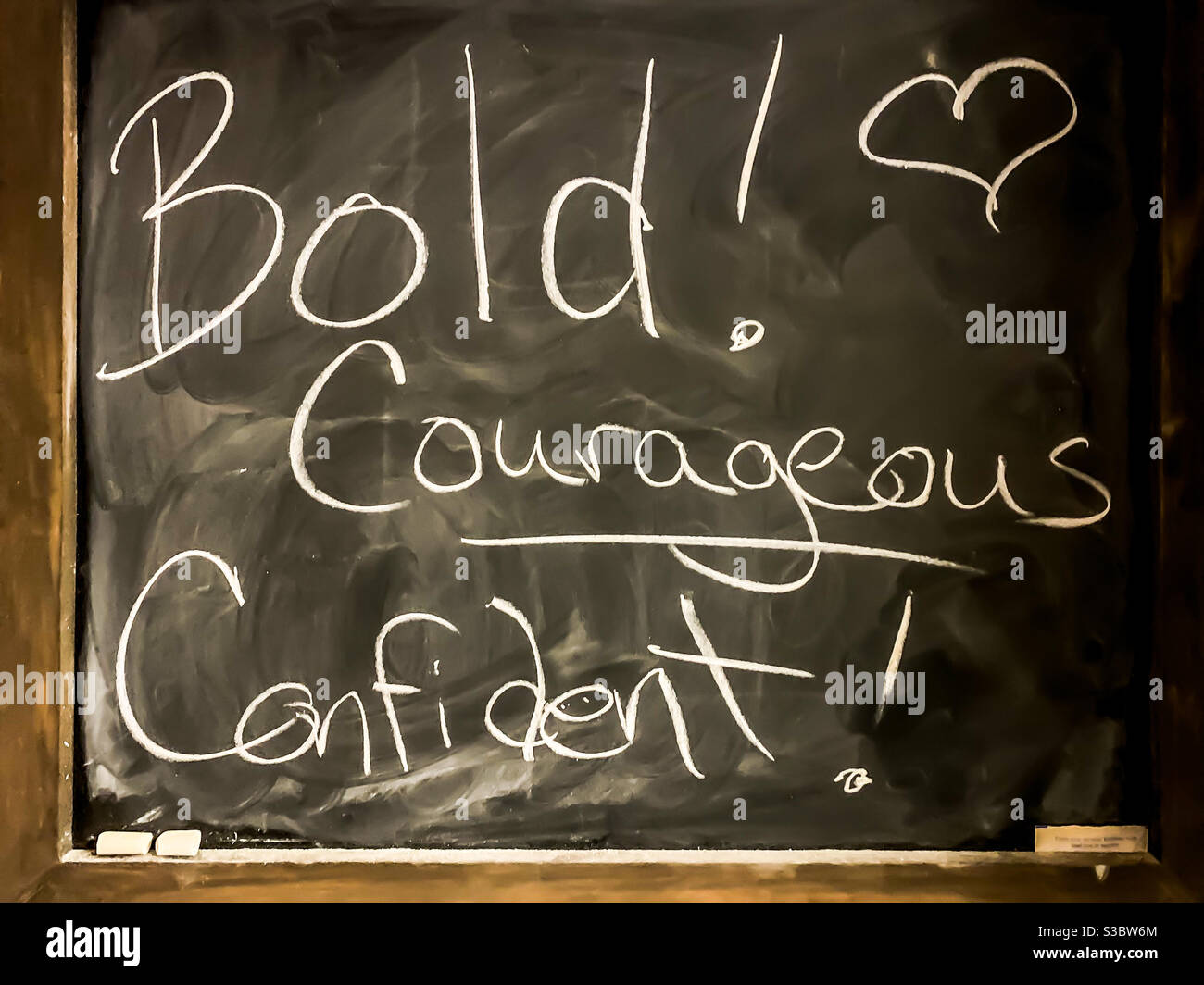 A chalkboard with encouraging words written on it. It says “Bold! Courageous! Confident”. - Smartphone Captured Stock Image