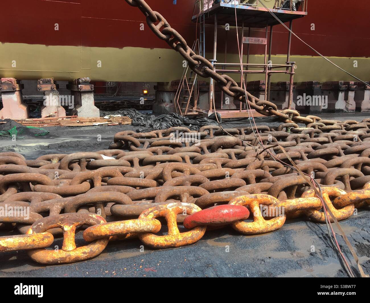 Anchor chain of cargo container vessel staying on supports in drydock