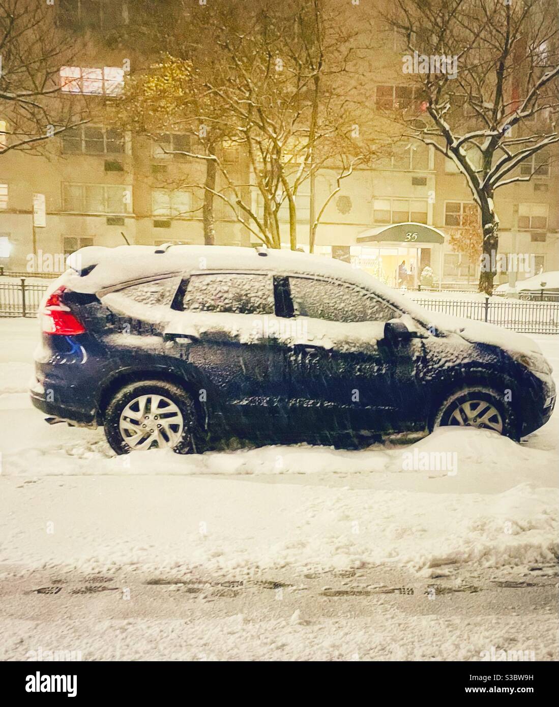 Snow-covered Toyota Prius parked on Park Avenue in New York City Stock Photo
