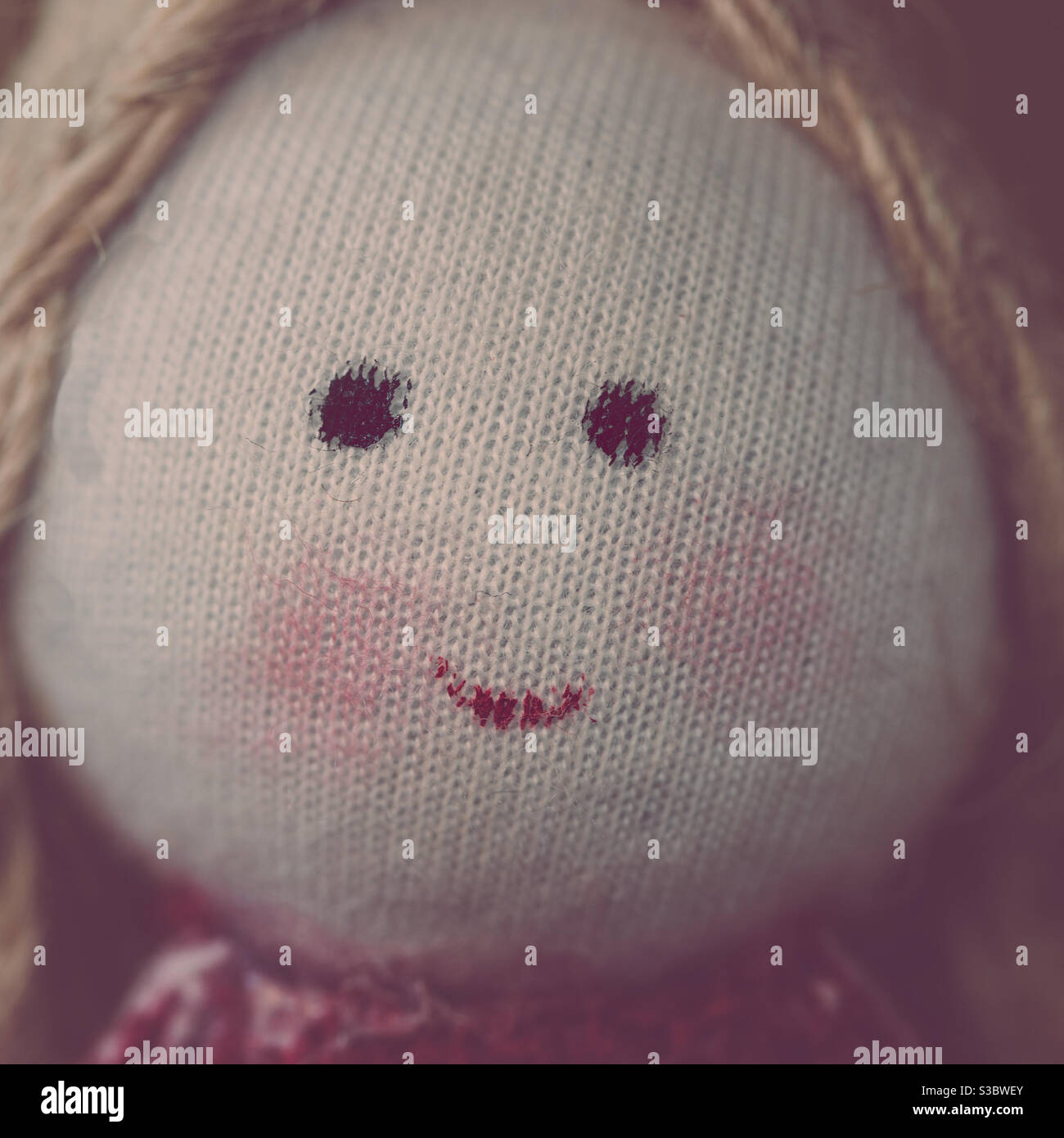 Close up of the smiling face of a girl handmade toy doll - Smartphone Captured Stock Image