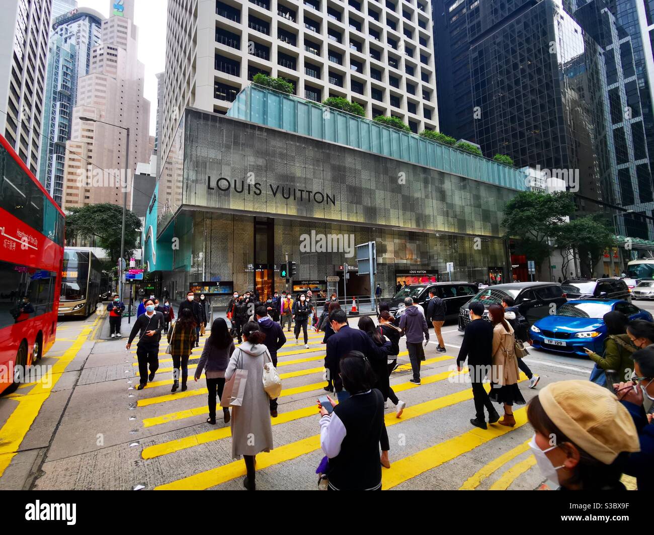 Pedestrians crossing Prdder street in Hong Kong's Central district. - Smartphone Captured Stock Image